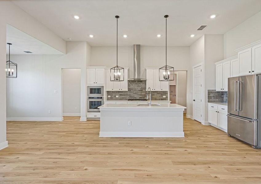 The kitchen has beautiful white cabinetry.