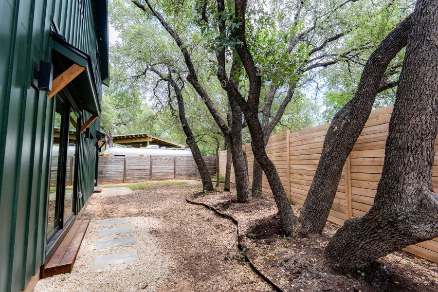 Mature trees and privacy fencing define this spacious, naturally illuminated private backyard. Mature trees and privacy fencing define this spacious, naturally illuminated private backyard.
