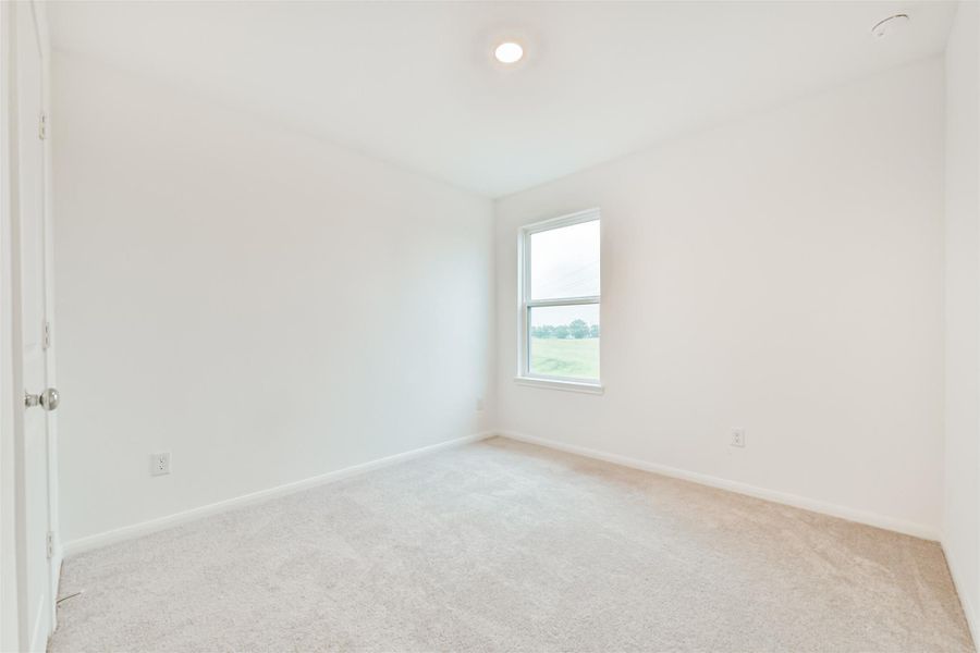 Bedroom #2 located on the second floor boasts a clean neutral space with ample natural lighting.