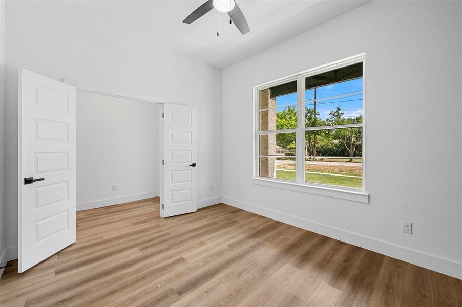 Unfurnished bedroom with light wood-type flooring and ceiling fan