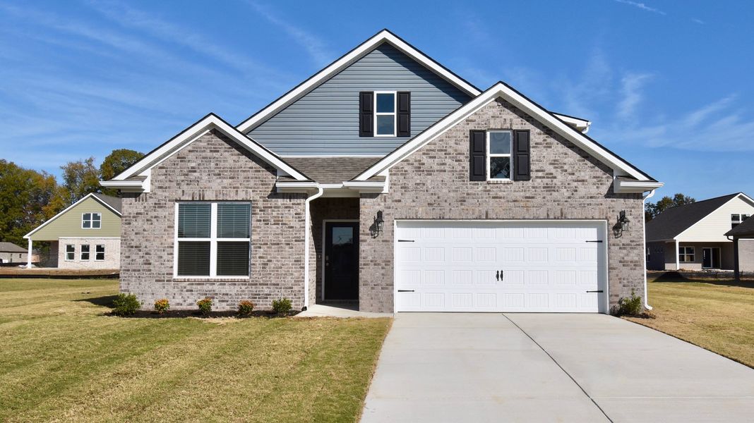 Front exterior of a new home in Village Park, Oakland, TN, highlighting curb appeal (Image 1).