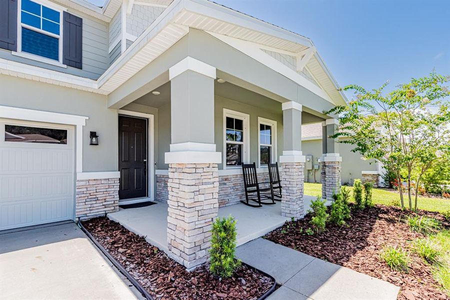Front exterior of a new home in Seasons at Lakeside Forest, Tavares, FL, highlighting curb appeal (Image 23).