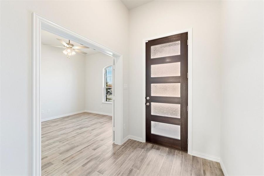 Entrance foyer featuring light wood-type flooring and ceiling fan