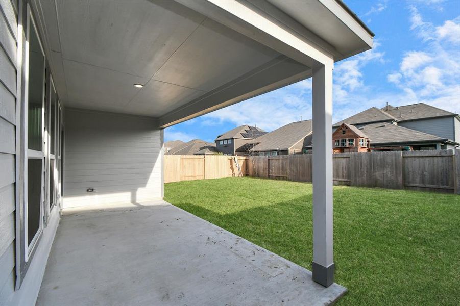 Expansive covered patio, thoughtfully designed for BBQs and delightful outdoor dining. Sample photo of completed home with similar floor plan. As-built interior colors and selections may vary.