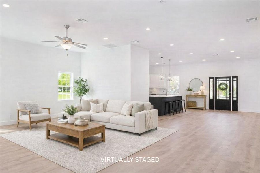 Virtually staged to illustrate the volume and vision of this great room