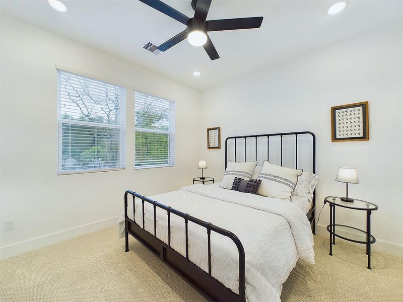 Secondary Bedroom located on the first floor. Vinyl windows with retractable panels allow in tons of natural light.