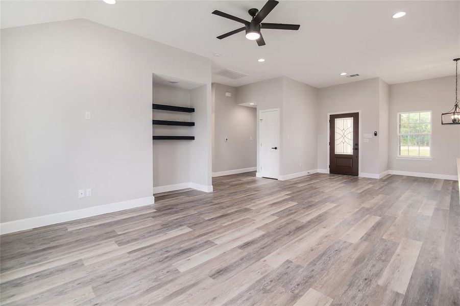 Easy-to-maintain luxury vinyl plank flooring runs throughout the home with carpet in the bedrooms and designer tile in the bathrooms.