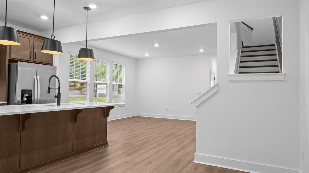 Exclusive DRB Homes kitchen with a 9-foot island, elevated finishes, and pendant lighting in a prime location Exclusive DRB Homes kitchen with a 9-foot island, elevated finishes, and pendant lighting in a prime location