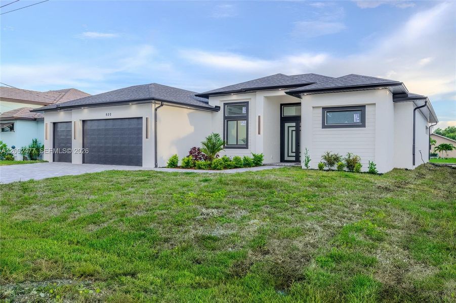 Front exterior of a new home in , Cape Coral, FL, highlighting curb appeal (Image 25). Front exterior of a new home in , Cape Coral, FL, highlighting curb appeal (Image 25).
