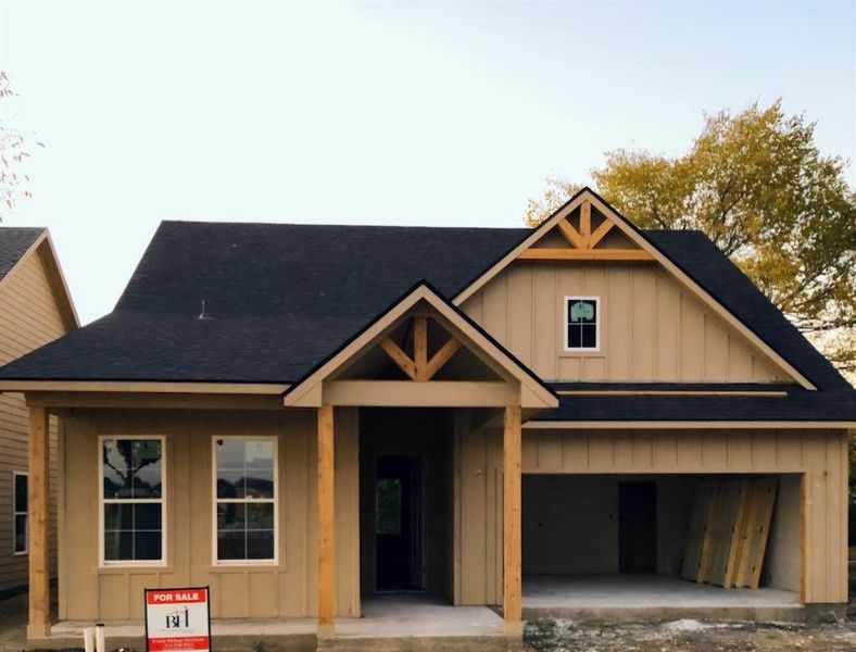 View of front of home with board and batten siding, a porch, and a shingled roof View of front of home with board and batten siding, a porch, and a shingled roof