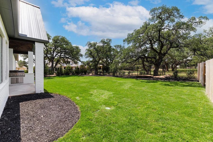 Front exterior of a new home in Caliterra - 110', Dripping Springs, TX, highlighting curb appeal (Image 19). Front exterior of a new home in Caliterra - 110', Dripping Springs, TX, highlighting curb appeal (Image 19).