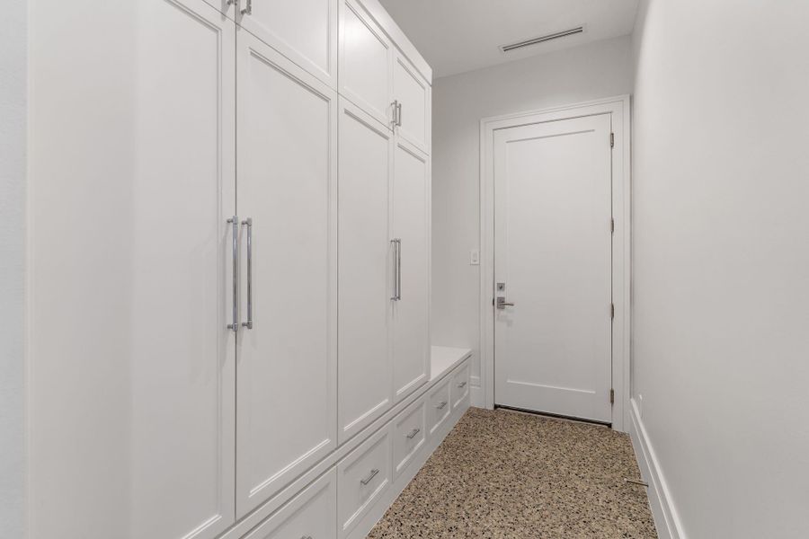 Mud room just off of garage with lockers and abundant storage.
