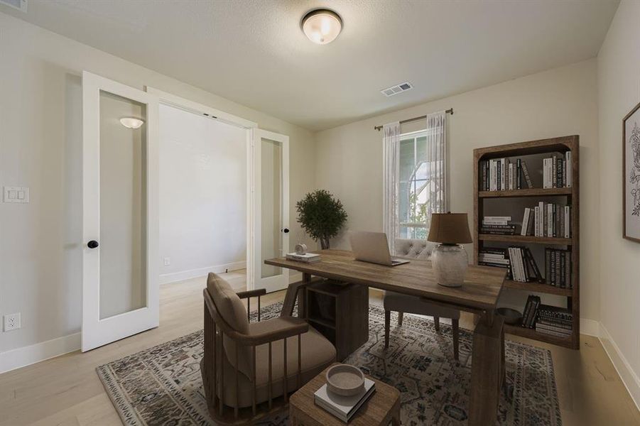 Virtually staged photo - Office area featuring light wood-type flooring