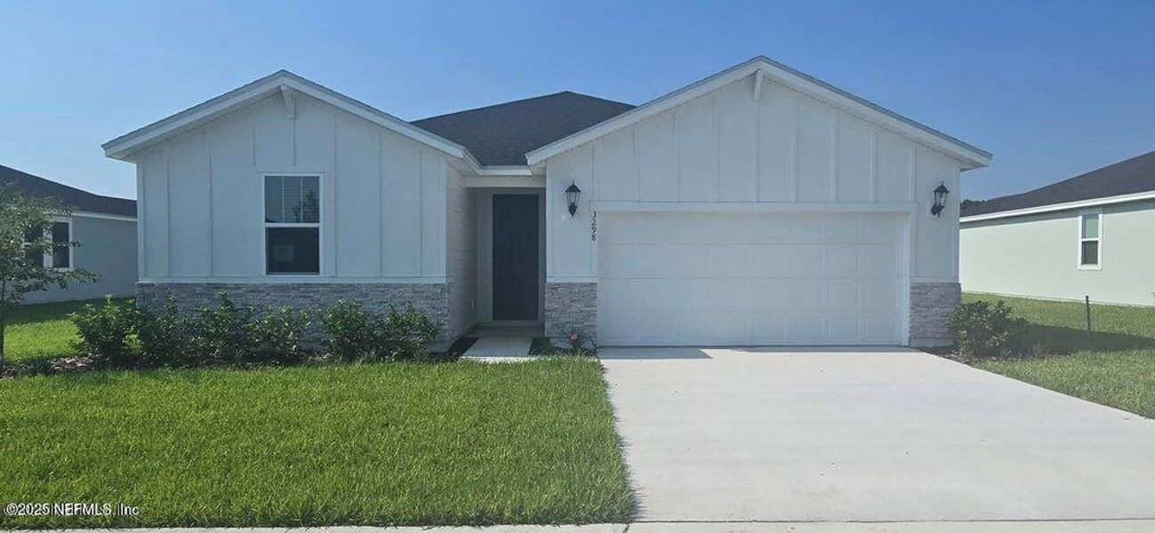 Front exterior of a new home in Lakes at Bella Lago - Signature Series, Green Cove Springs, FL, highlighting curb appeal (Image 2). Front exterior of a new home in Lakes at Bella Lago - Signature Series, Green Cove Springs, FL, highlighting curb appeal (Image 2).