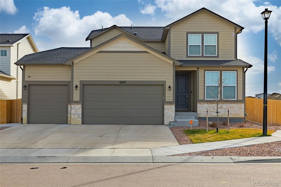 Front exterior of a new home in , Colorado Springs, CO, highlighting curb appeal (Image 22).