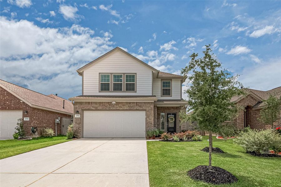 Front exterior of a new home in Tavola: Gulf Coast Collection, New Caney, TX, highlighting curb appeal (Image 2). Front exterior of a new home in Tavola: Gulf Coast Collection, New Caney, TX, highlighting curb appeal (Image 2).
