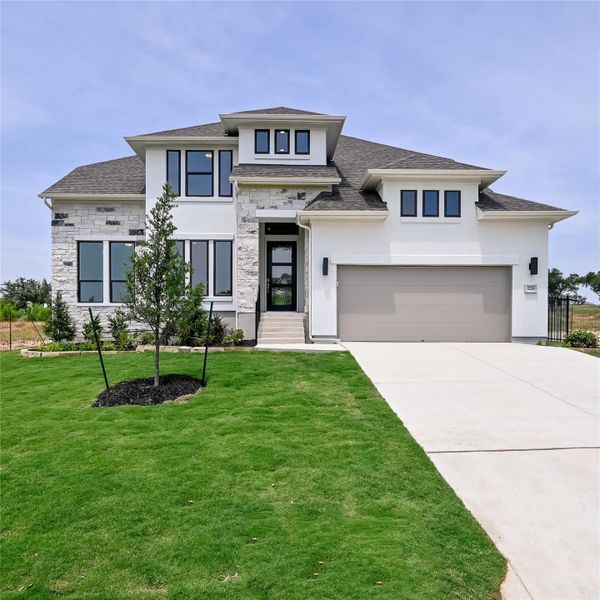 Prairie-style home with stucco siding, driveway, stone siding, and a garage Prairie-style home with stucco siding, driveway, stone siding, and a garage