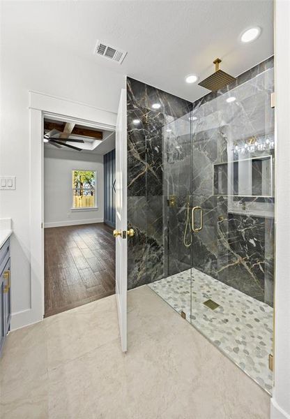 Full bathroom featuring beamed ceiling, vanity, a marble finish shower, coffered ceiling, and wood finished floors Full bathroom featuring beamed ceiling, vanity, a marble finish shower, coffered ceiling, and wood finished floors
