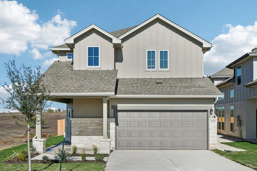 Front exterior of a new home in Porter Country, Buda, TX, highlighting curb appeal (Image 1). Front exterior of a new home in Porter Country, Buda, TX, highlighting curb appeal (Image 1).