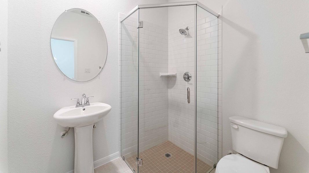 Bathroom featuring toilet and a shower stall