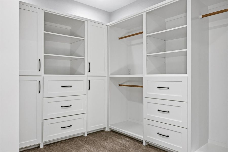 Primary custom cabinetry Walk in closet