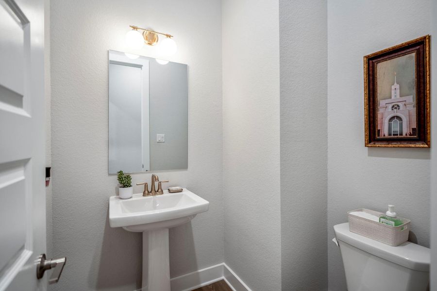 This first-floor powder bathroom is perfect for everyday use, while two additional full ensuite bathrooms provide added privacy and flexibility downstairs.