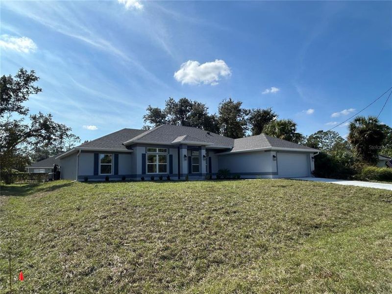 Front exterior of a new home in North Port, North Port, FL, highlighting curb appeal (Image 1). Front exterior of a new home in North Port, North Port, FL, highlighting curb appeal (Image 1).