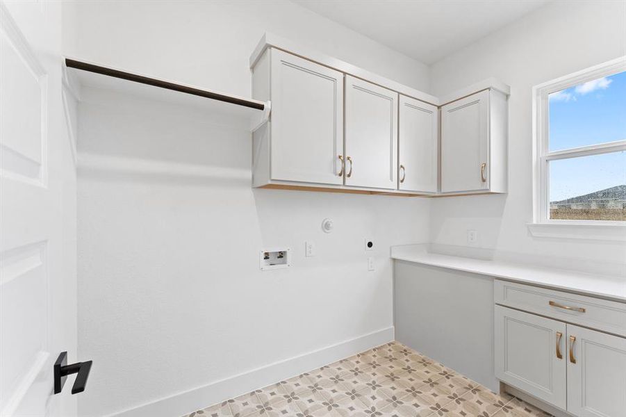 Utility Room with Washer and Dryer Connections, Hanging Bar, Storage, and Built-in Folding Area.