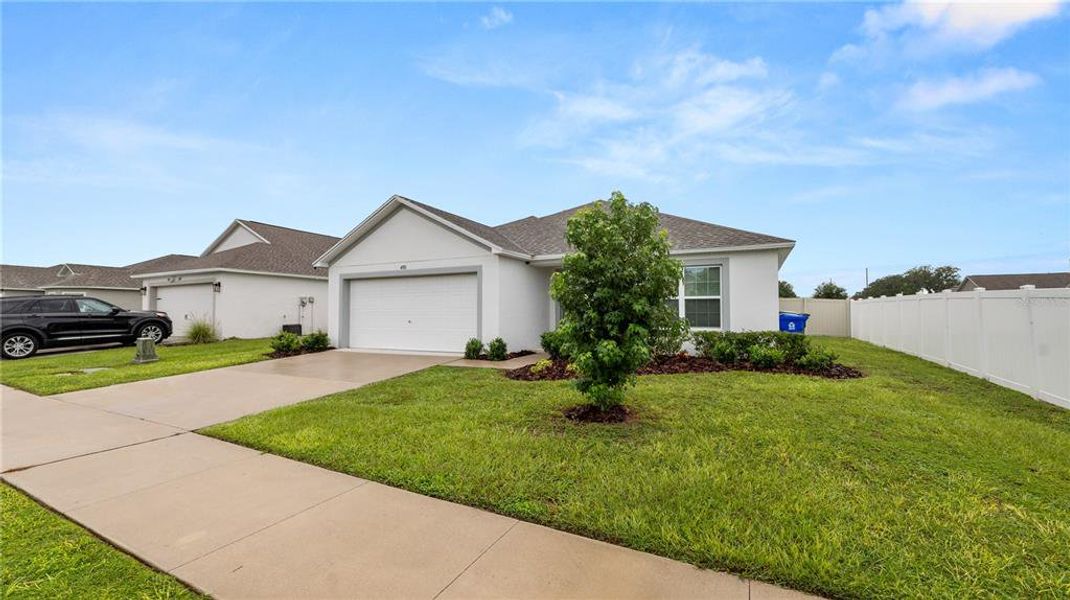 Front exterior of a new home in Gresham Farms Village, Lakeland, FL, highlighting curb appeal (Image 20). Front exterior of a new home in Gresham Farms Village, Lakeland, FL, highlighting curb appeal (Image 20).