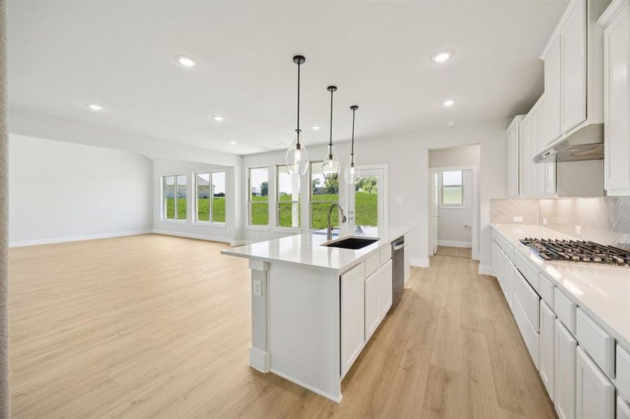 Kitchen featuring white cabinetry, plenty of natural light, light wood-style flooring, and recessed lighting
