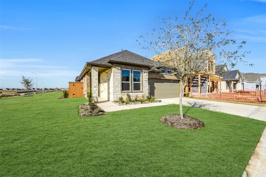 Front exterior of a new home in Sunterra, Katy, TX, highlighting curb appeal (Image 23).