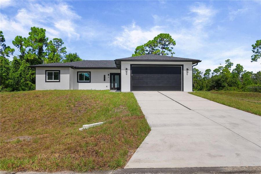 Front exterior of a new home in , Lehigh Acres, FL, highlighting curb appeal (Image 1). Front exterior of a new home in , Lehigh Acres, FL, highlighting curb appeal (Image 1).