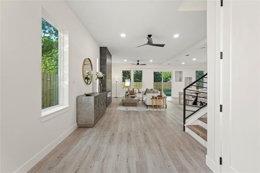 Corridor featuring light wood-type flooring, stairs, and recessed lighting Corridor featuring light wood-type flooring, stairs, and recessed lighting