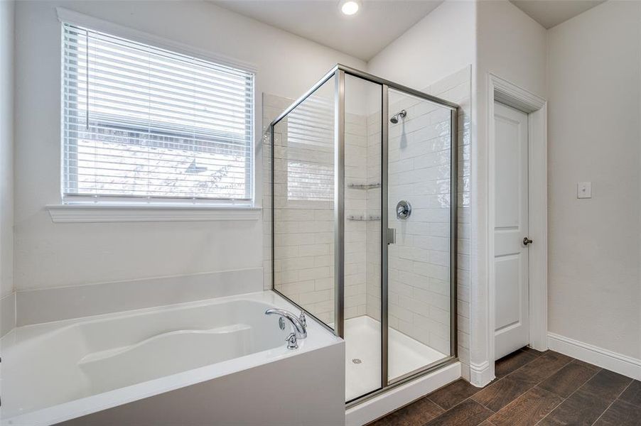 Bathroom separate tub and shower and dual vanities.