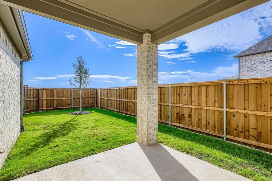 Fenced backyard with a patio area Fenced backyard with a patio area
