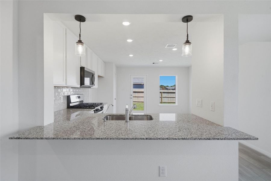 This spacious kitchen has it all—ample storage, generous counter space, and a layout that truly makes it the heart of the home.