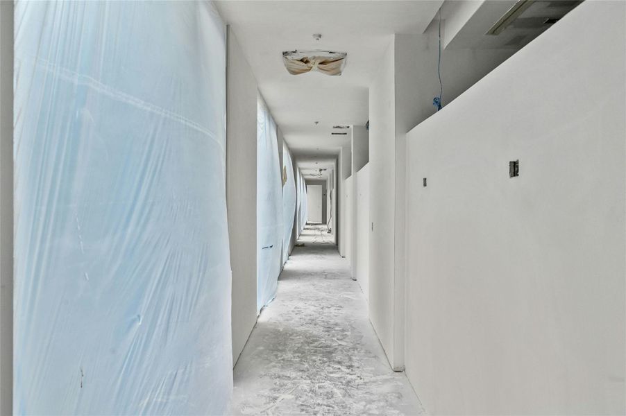 Corridor with unfinished concrete flooring