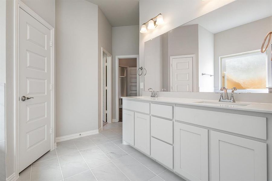 Bathroom featuring tile patterned flooring and vanity