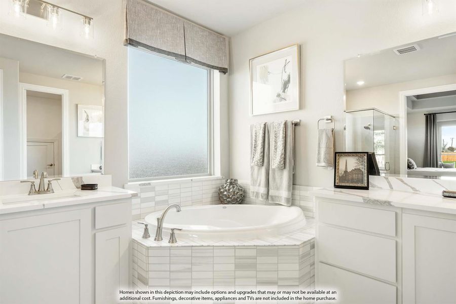Master bathroom with corner soaking tub, dual vanities, white cabinets, and tile surround near a frosted window