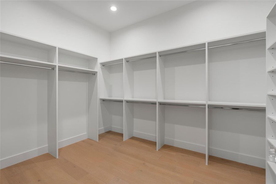 One of two custom walk-in closets with built-in shelving and exceptional storage space.