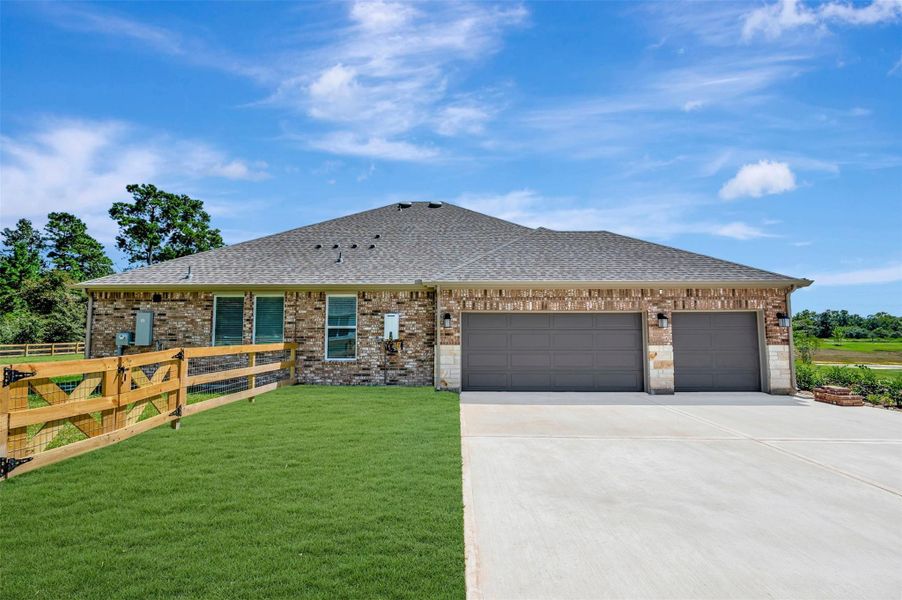 Front exterior of a new home in Lone Star Landing, Montgomery, TX, highlighting curb appeal (Image 22). Front exterior of a new home in Lone Star Landing, Montgomery, TX, highlighting curb appeal (Image 22).