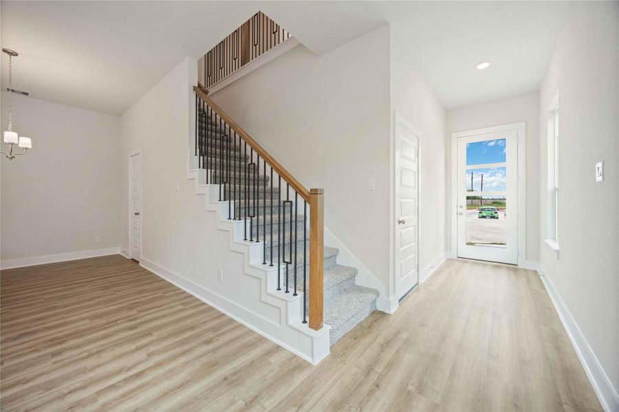 Check out the elegant iron stair rails with beautiful wood handrails.