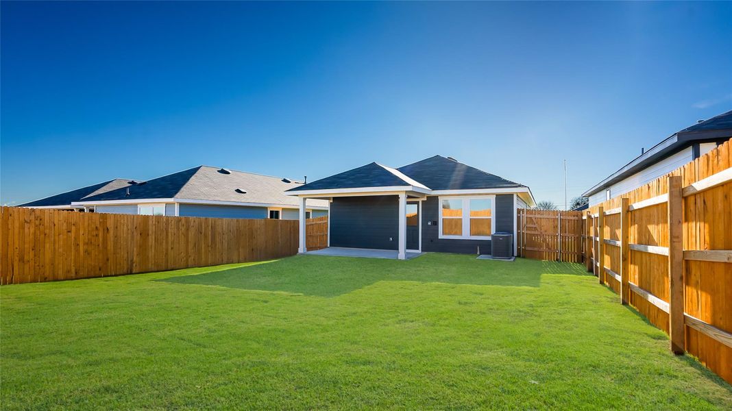 Front exterior of a new home in Marigold, Uhland, TX, highlighting curb appeal (Image 13). Front exterior of a new home in Marigold, Uhland, TX, highlighting curb appeal (Image 13).