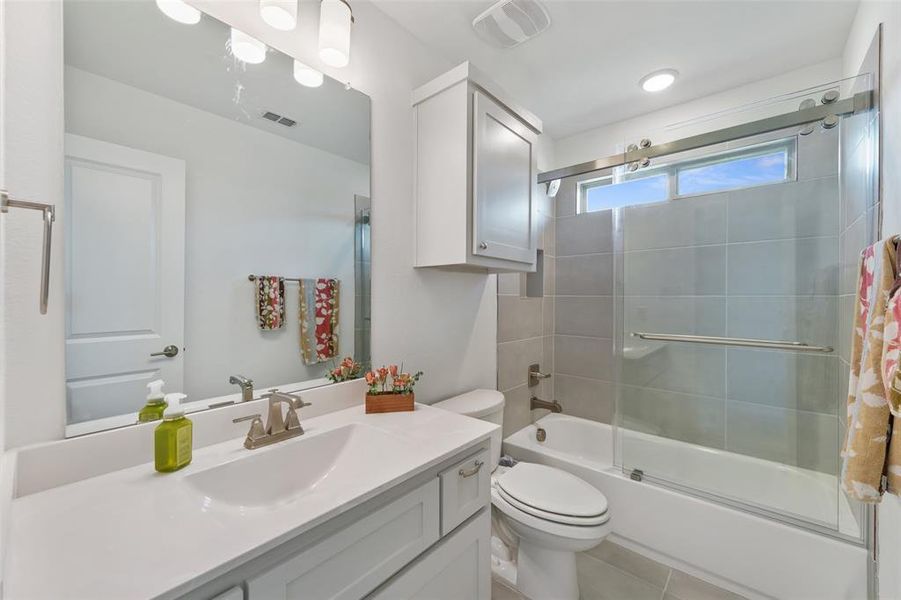 Upstairs Guest Bath #2 features tub shower combo