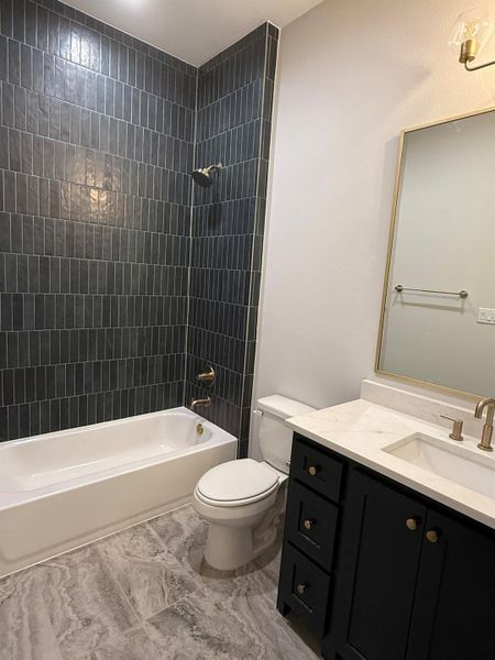 Bathroom with vanity and shower / tub combination