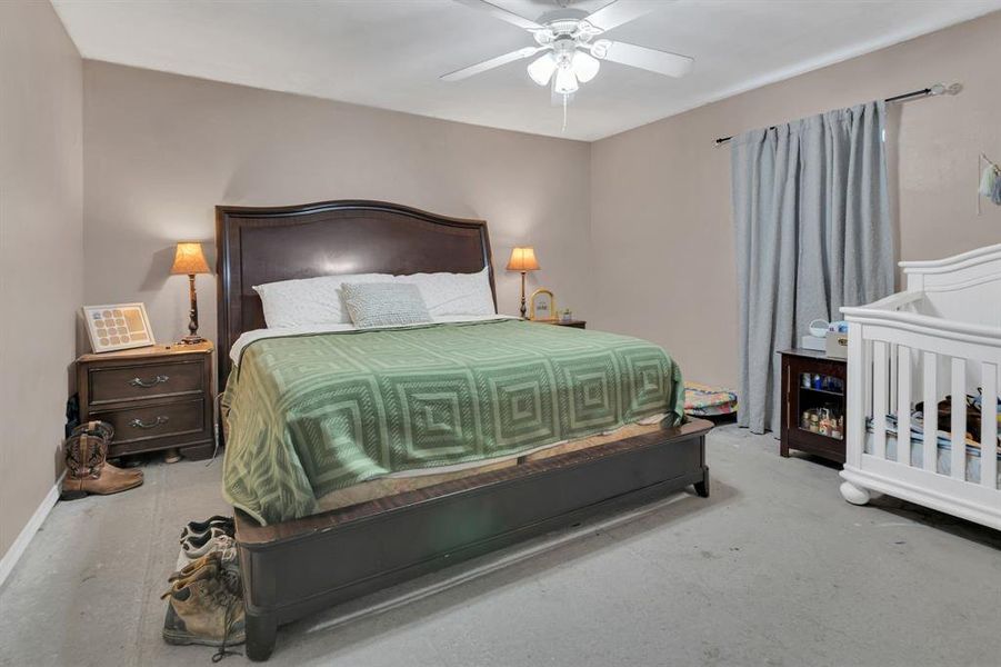 Bedroom with a ceiling fan and baseboards Bedroom with a ceiling fan and baseboards