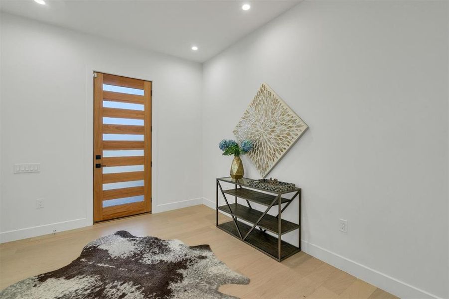 Entryway with light wood-style floors and recessed lighting Entryway with light wood-style floors and recessed lighting