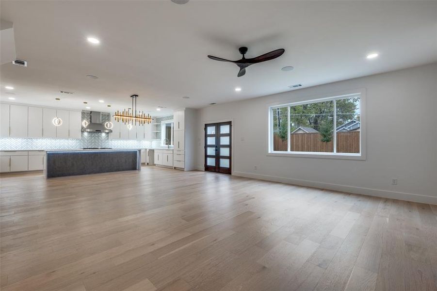 Living room featuring light wood-style flooring, recessed lighting, and ceiling fan