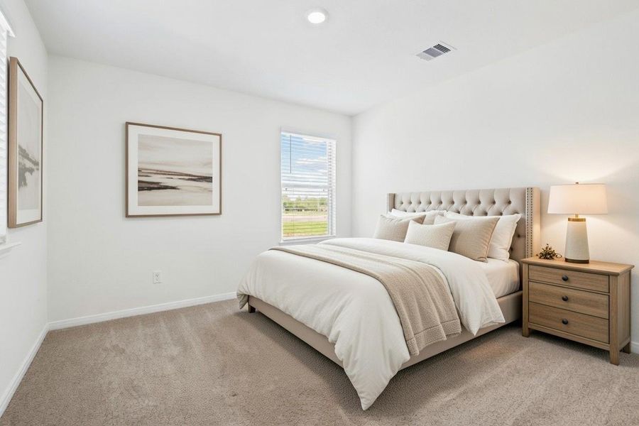 This secondary bedroom combines comfort and style, featuring plush carpeting, neutral paint, recessed lighting, a large window with blinds, and a spacious closet.