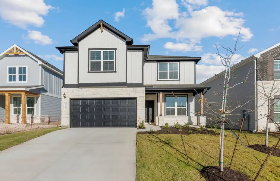 Front exterior of a new home in Patterson Ranch, Georgetown, TX, highlighting curb appeal (Image 1).